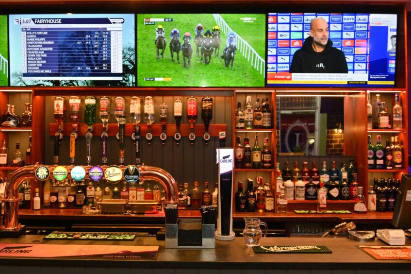 The bar with TV screens above it showing various sports 