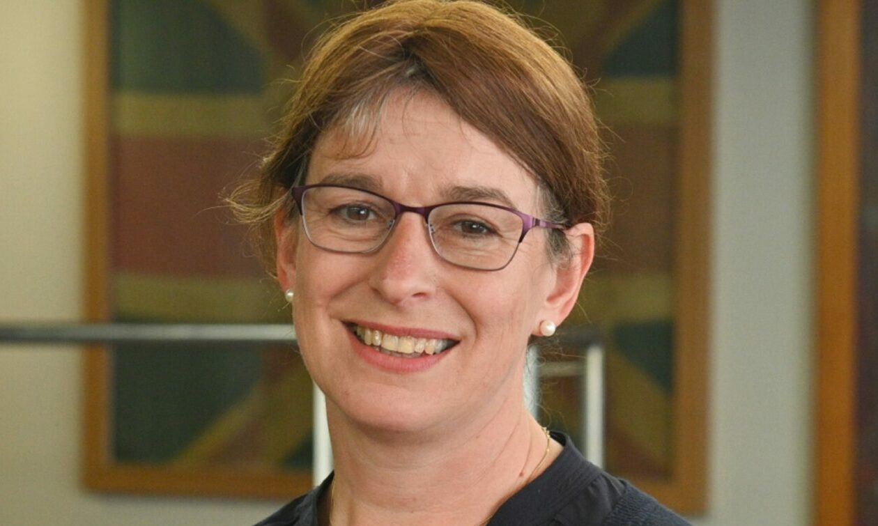 Profile photo of Kathleen Robertson smiling at camera. 