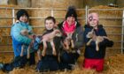 Lyla Davies, Ryan Davies, Joy Davies and Ailsa Davies with the newborn lambs. Image: Kenny Elrick/DC Thomson.