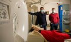 Prof Roger Staff and Dr Prakash Abraham with NHS Grampian patient Mae Donald and the PET-CT scanner which helped her get a thyroid diagnosis and changed her life. Image: Kami Thomson/ DC Thomson