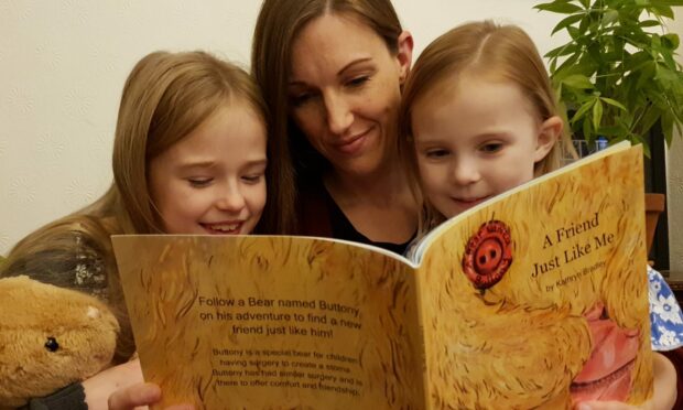 Kathryn Bradley, who wrote the book, reads it to her children. Image: A Bear Named Buttony