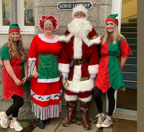 Michelle Clark, with Santa and two elves
