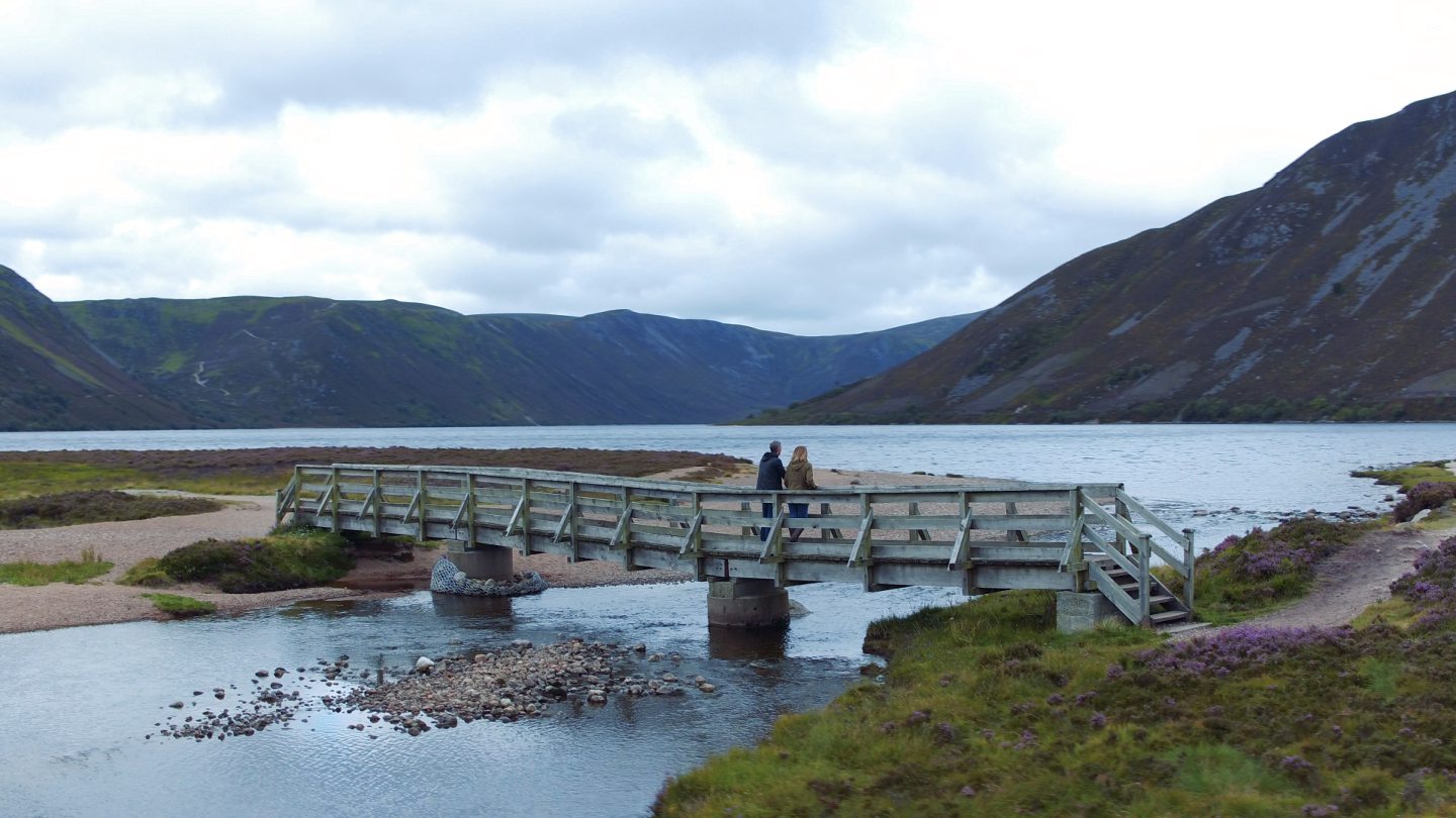 Visitors enjoying a stroll around Loch Muick.