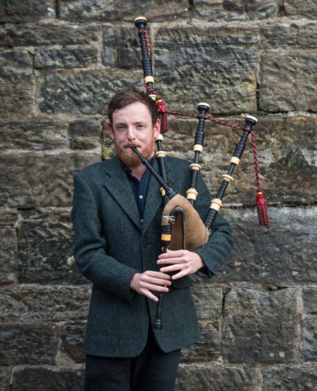 James Duncan Mackenzie playing bagpipes 