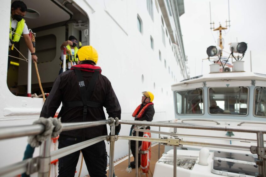 Worker at Orkney Harbour - Marine team servicing liner 