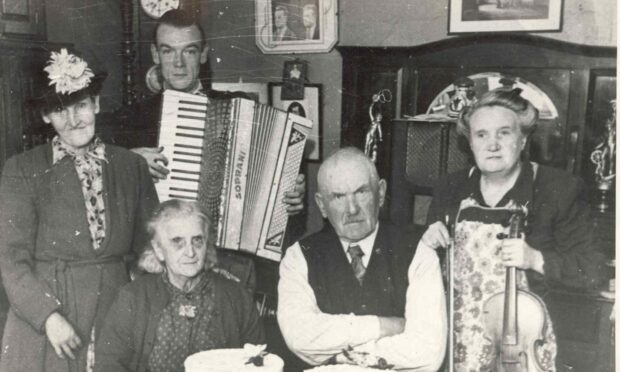 Mary Brooksbank with nephew Fred Soutar (with accordion), parents Rosie and Sandy Soutar (seated) and their friend Mrs Hughes (standing), at her parents' diamond wedding anniversary in 1948