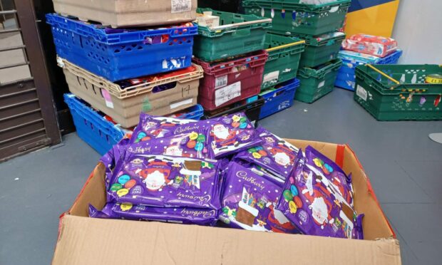 Poundland in the Trinity Centre has donated many boxes full of selection boxes for Cfine to distribute. Image: Lottie Hood/DC Thomson.