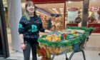 Michelle Jamieson, deputy manager for Slains Castle, dropped off a trolley full of food items to the Big Christmas Food Appeal's drop-off point at The Trinity Centre. Image: Erikka Askeland/DC Thomson.