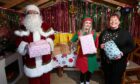 Santa with Katie Thomson and Michelle Clark in Santa's grotto. Image Darrell Benns/DC Thomson