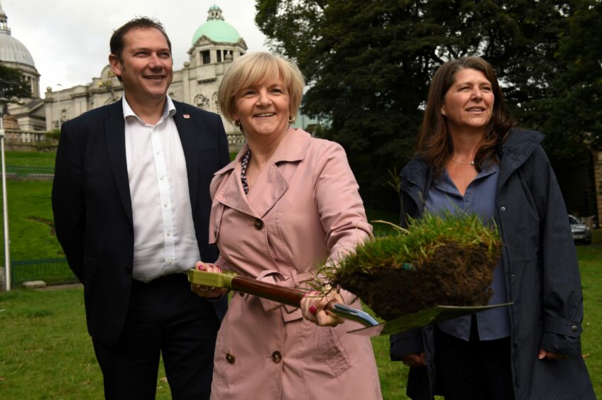Former Labour council leader Jenny Laing cuts the sod in Union Terrace Gardens in August 2019, alongside her Conservative co-leader Douglas Lumsden and independent administration partner Marie Boulton. Image: Kenny Elrick/DC Thomson.