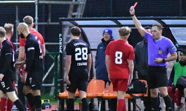 Peterhead's Russell McLean is shown a red card by referee Chris Graham as Andy McCarthy (8) protests the decision. Image: Duncan Brown.