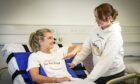 Roma Gibb and volunteer testing the Bed Band in a hospital setting.