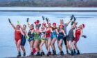 Members of the Loch Insh Dippers wild swim group take part in a Christmas-themed swim in Loch Insh in the Cairngorms National Park near Aviemore, Scotland. Image: Jane Barlow/PA Wire.