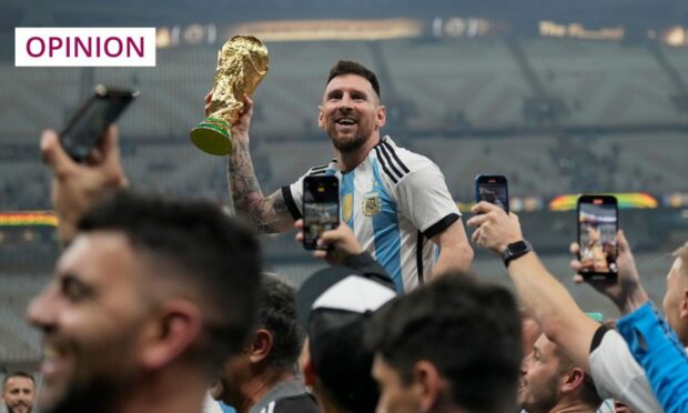 Argentina's Lionel Messi holds the World Cup aloft (Image: Dave Shopland/Shutterstock)
