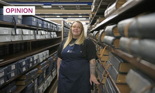 National Library of Scotland newspaper conservator, Claire Hutchison, pictured among the vast archive (Image: Alison Gibson/National Library of Scotland/PA)