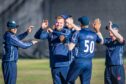 Mark Watt, centre, was among the wickets for Scotland against Nepal. Image: Wullie Marr/DC Thomson