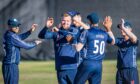 Mark Watt, centre, was among the wickets for Scotland against Nepal. Image: Wullie Marr/DC Thomson