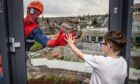 Fraserburgh youngster Jamie Gibb, 8, meets one his heroes during a surprise visit to Royal Aberdeen Children's Hospital. Superheroes abseiled down the building.