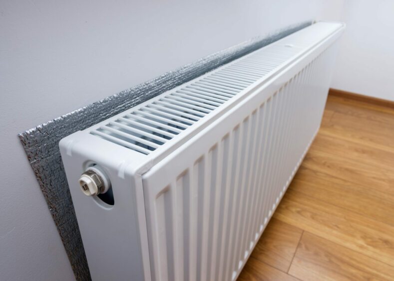 Foil behind a radiator to help keep your home warm
