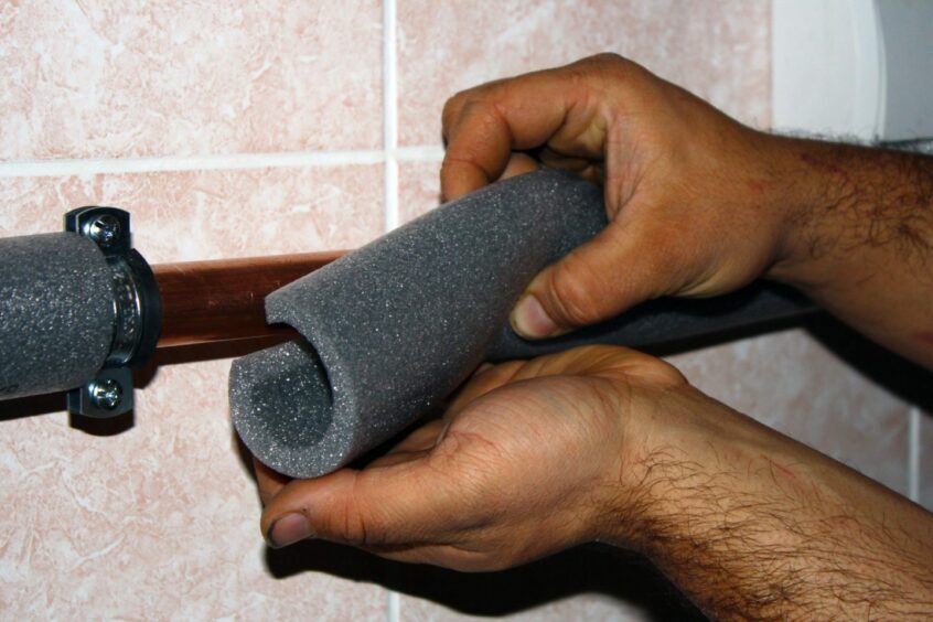 Foam sleeves being added to a pipe to keep in heat