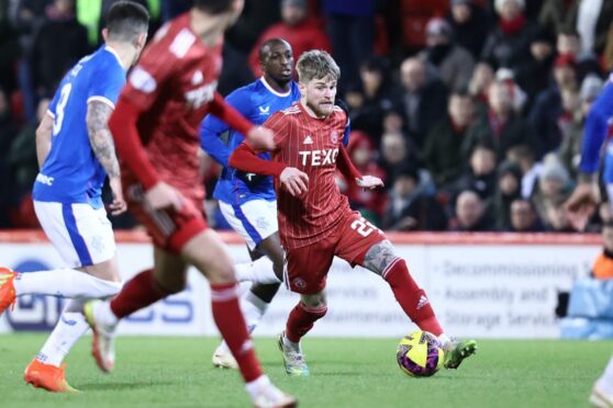 Hayden Coulson on the ball for Aberdeen against Rangers. Image: Shutterstock.
