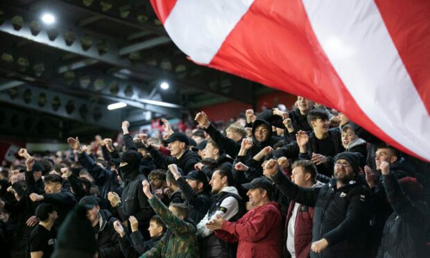 Aberdeen supporters cheer on the Dons against St Johnstone. Image: Shutterstock
