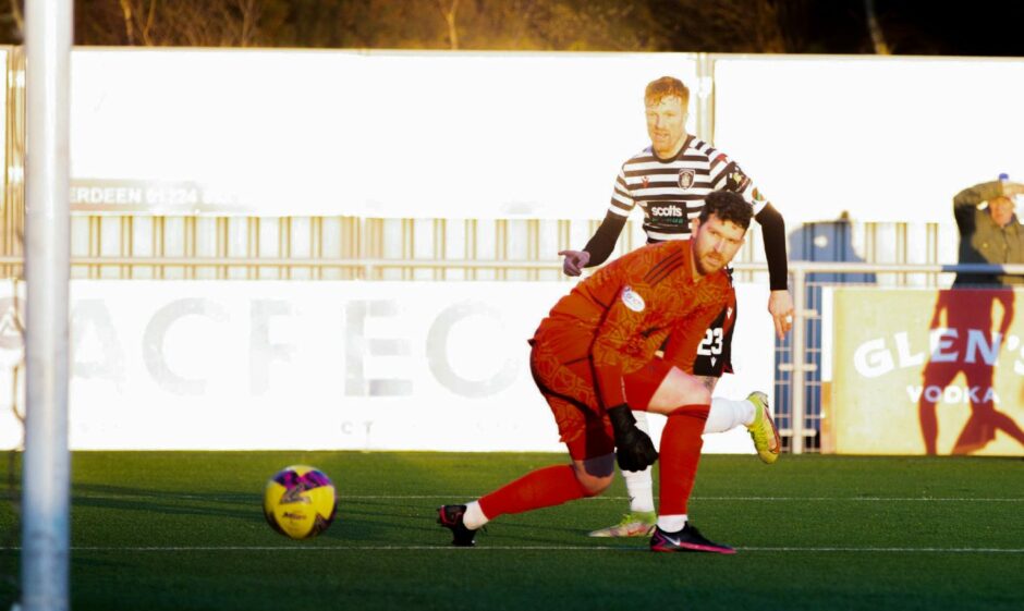 Stuart McKenzie watches on as his attempted pass comes straight back off Simon Murray into the net. Image: SNS