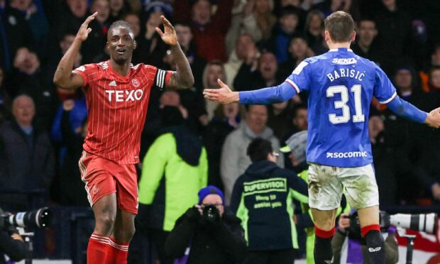 Aberdeen captain Anthony Stewart is shown a straight red card for a foul on Rangers' Fashion Sakala. Image: SNS