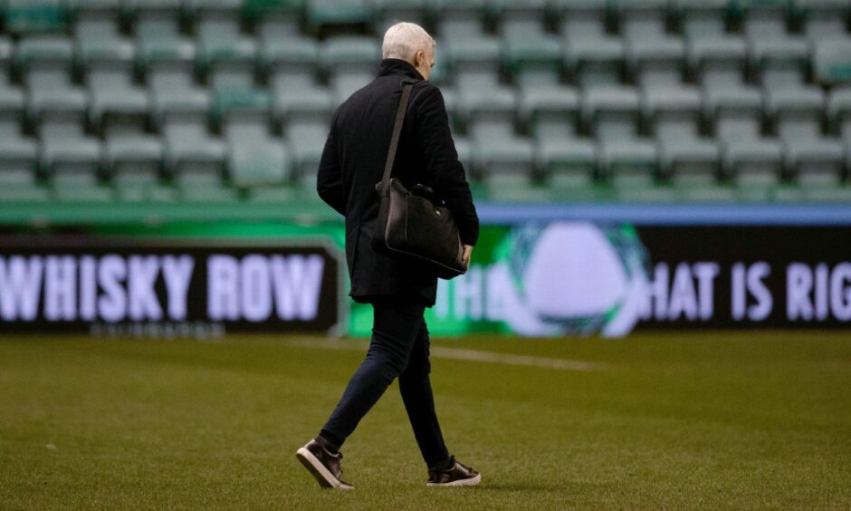 Jim Goodwin walking across the pitch after losing his job as Aberdeen manager