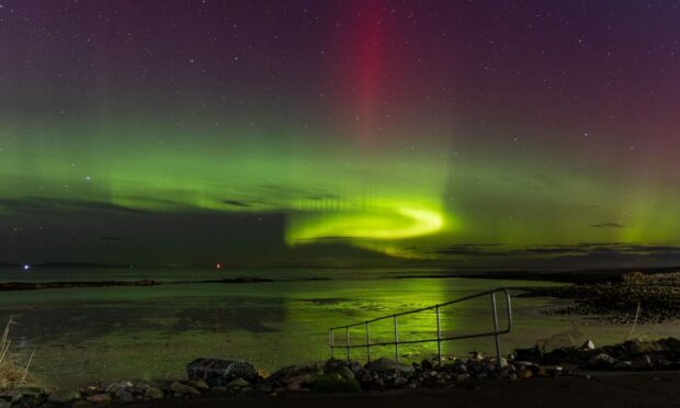 The Northern Lights swirling above Lossie beach. Image: Joanna Barnes / Above & Beyond Captures.