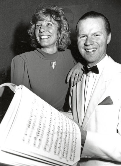 An actor and actress from Studio Theatre Group with sheet music in front of them