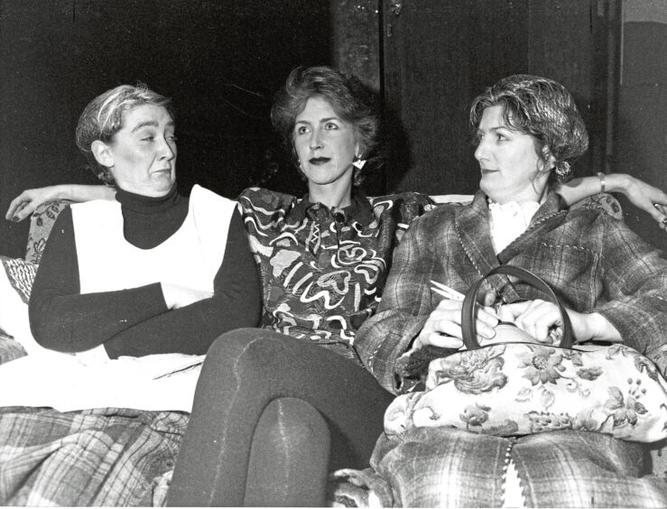 Three women in the Studio Theatre Group sat on a couch