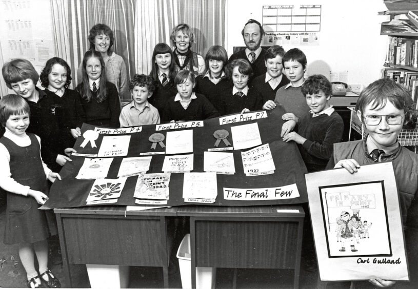 1982 - Carl Gulland, right, after his cartoon character was chosen to introduce Banchory Primary School children to their new magazine.