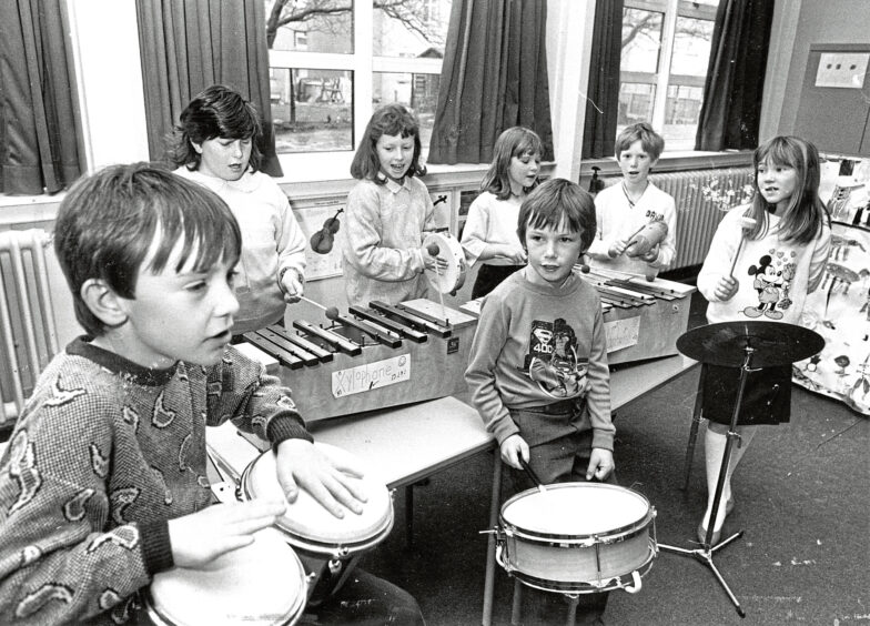 Children from Kaimhill school playing percussion instruments including xylophones and drums