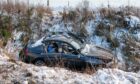The black BMW crashed off the snowy A95 near Grantown on Spey.  Image: Jasperimage