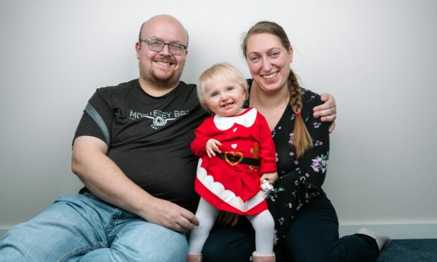 19-month-old Isabella with her parents Richard Winfield and Margaret Paluszynka, at a Travelodge Hotel in Glasgow. Image: The Sunday Post.