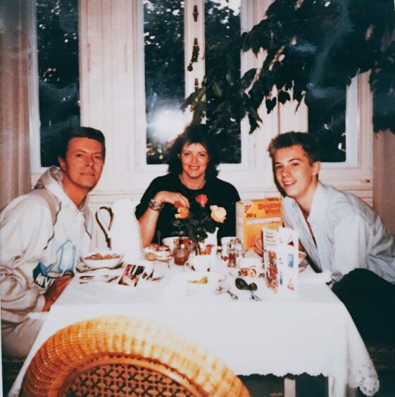 David Bowie, a smiling Marion Skene and Duncan Jones sitting and eating breakfast together 