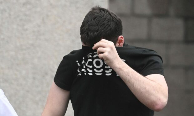 Calvin Gallon hid his face as he was taken into custody from Aberdeen Sheriff Court. Image: DC Thomson