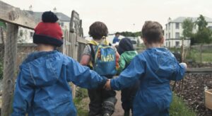 Children playing together at outdoor nursery in the Highlands