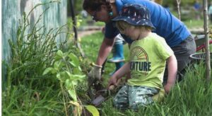 Child working in garden at outdoor nursery in the Highlands