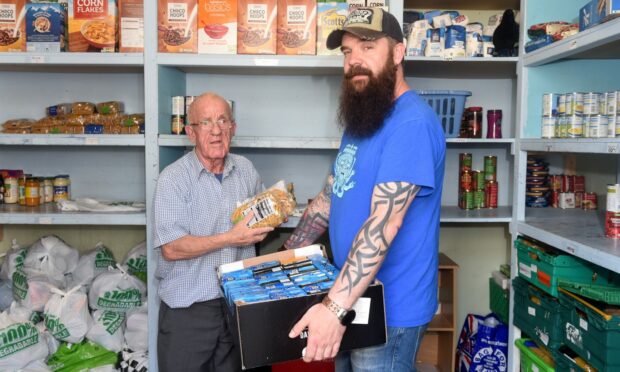 Evan Adamson, Instant Neighbour's community connector, with volunteer Douglas McDonagh at the Aberdeen foodbank in 2019. Image: Darrell Benns/DC Thomson.