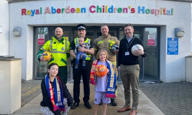 Emergency services come together with Archie Mascots, Kier, Izzy and Taylor to launch Battle of the Badges event. Pictured is Scott Burnett from SAS, Aaron Scoular from the police, Matthew Cowe from SFRS and Mike Reidy. from NHS. Image: The Archie Foundation.
