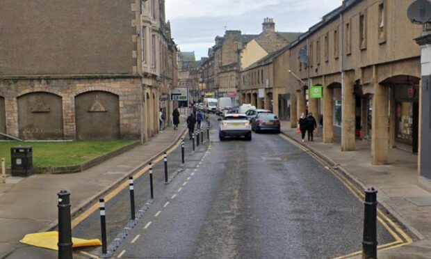 Cones next to Elgin High Street footpath used for social distancing