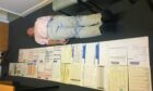 Dr Gordon Caldwell lying next to all the patient paperwork.