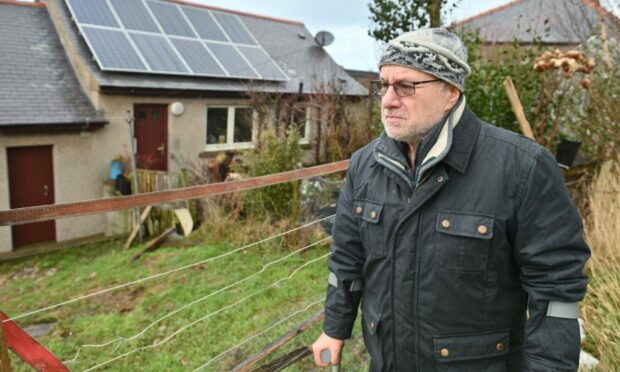 Stan Watt, 63 is freezing in his home. Solar panels on his roof that could reduce his bills have never been connected up by the council. Image: Jason Hedges/ DC Thomson