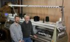 (L-R): Garry and father, Peter Jamieson, with a new knitting machine for their fifth-generation business: Image: Ben Mullay.