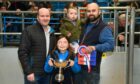 The overall champion prize in ANM's anniversary show and sale went to Steven Smith, pictured with children Lily and Jack, and sponsor Eric Thomson. Image: Kenny Elrick/DC Thomson