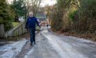 Graham Wales is concerned about the sheet of ice that forms on his road due to a leak every winter in Peterculter. Image: Kath Flannery/DC Thomson