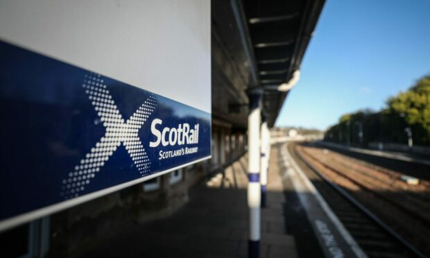 A ScotRail sign inside a train station.