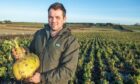 Stewart Davidson of West Cortiecram, Mintlaw, with his award winning turnips. Image: Kami Thomson/DC Thomson